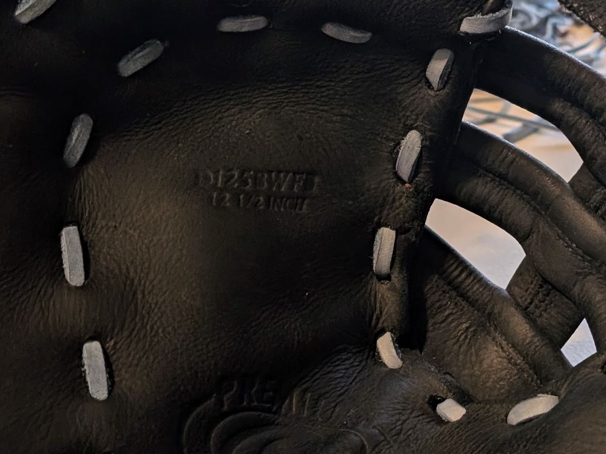 Repaired black Rawlings Premium first base mitt relaced with grey lace