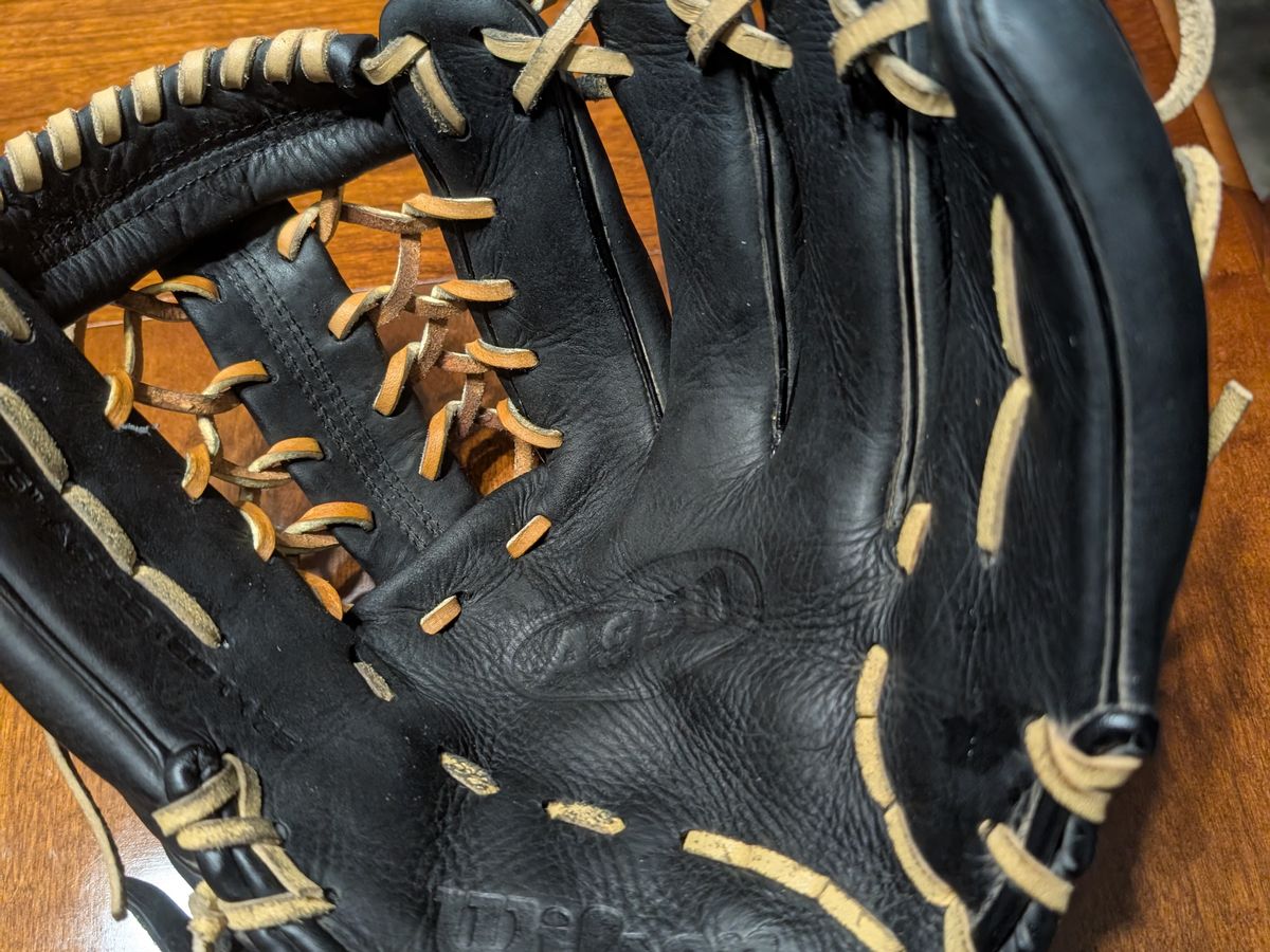 Black Wilson glove relaced with blonde lace